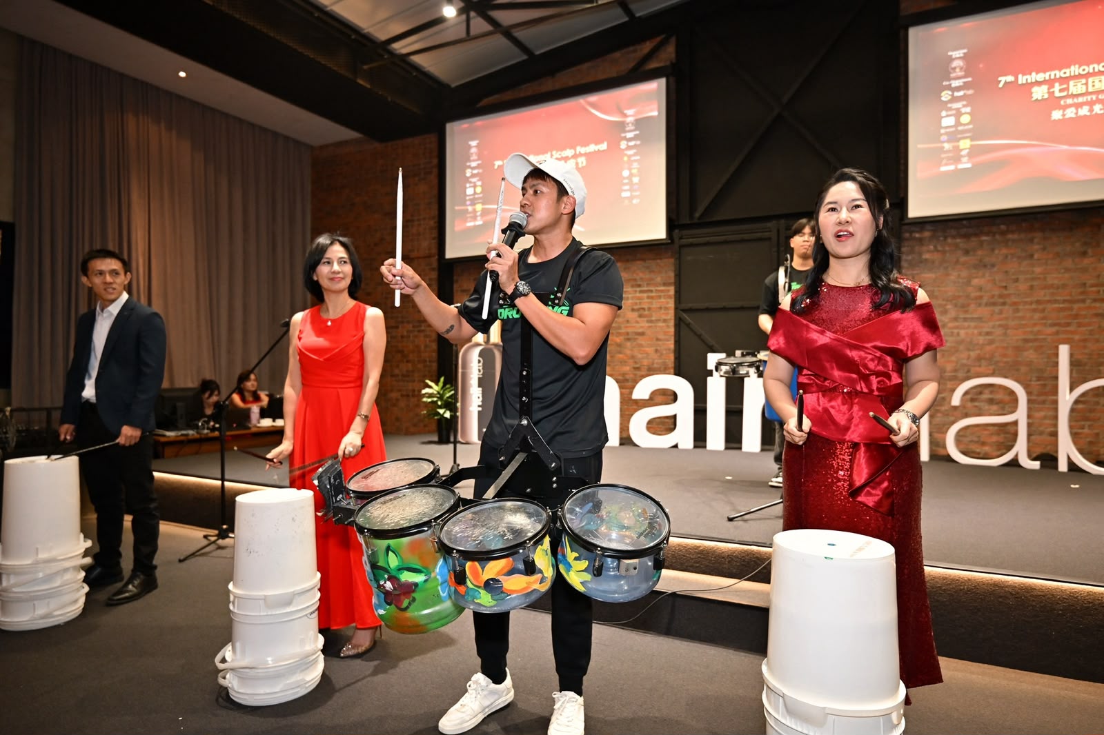Guests joining an interactive upcycled drumming session on stage